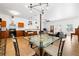 Bright, open-concept living area featuring modern lighting, a dining table, and hardwood floors at 2224 E 10Th Ave, Tampa, FL 33605