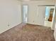 Bedroom offers neutral carpeting and a view into the adjacent living space at 2331 Finlandia Ln # 43, Clearwater, FL 33763