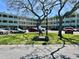 Exterior of Hawaiian Towers building with mature trees and a well-kept lawn with signage at 2331 Finlandia Ln # 43, Clearwater, FL 33763