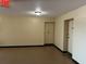 Hallway with two doors and neutral-colored walls, lit by a ceiling light at 2331 Finlandia Ln # 43, Clearwater, FL 33763