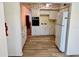 Traditional kitchen with wood flooring, appliances, and decorative wallpaper at 2331 Finlandia Ln # 43, Clearwater, FL 33763