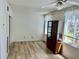 A simple living room features wood flooring, natural light, and a ceiling fan at 2331 Finlandia Ln # 43, Clearwater, FL 33763