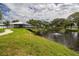 Picturesque view of a pond with a pavilion and lush green landscaping at 2331 Finlandia Ln # 43, Clearwater, FL 33763