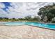 Large pool surrounded by brick pavers, chairs, greenery, and blue skies at 2331 Finlandia Ln # 43, Clearwater, FL 33763