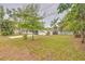 Backyard view of the home, showcasing the lawn and additional building on the property at 2412 53Rd S St, Gulfport, FL 33707
