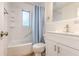 Clean bathroom featuring a tub with shower, white vanity, and tiled walls at 2412 53Rd S St, Gulfport, FL 33707