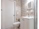 Bathroom features decorative tiled walls, toilet, vanity, and shower with glass doors at 2412 53Rd S St, Gulfport, FL 33707
