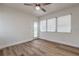 A bright bedroom featuring sleek wood floors, a ceiling fan, and a glass exterior door at 2412 53Rd S St, Gulfport, FL 33707