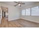 Comfortable bedroom showcasing wood-look flooring, two windows, and a ceiling fan at 2412 53Rd S St, Gulfport, FL 33707