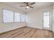 Well-lit bedroom features a ceiling fan, wood-look flooring, and access to the outdoors at 2412 53Rd S St, Gulfport, FL 33707