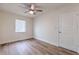 Comfortable bedroom with modern ceiling fan, wood-look flooring, and neutral walls at 2412 53Rd S St, Gulfport, FL 33707