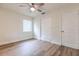 Bright bedroom featuring wood-look flooring, ceiling fan, and closet with built-in drawers at 2412 53Rd S St, Gulfport, FL 33707
