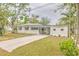 Charming single-story home features a well-maintained lawn and a long driveway leading to a carport at 2412 53Rd S St, Gulfport, FL 33707