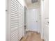 Hallway featuring wood-look floors, white walls, and closet with shuttered doors at 2412 53Rd S St, Gulfport, FL 33707