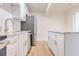 Bright kitchen features white cabinets, stainless steel appliances, and granite countertops at 2412 53Rd S St, Gulfport, FL 33707