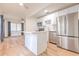 Modern open kitchen with stainless steel appliances, white cabinets, island and wood floors at 2412 53Rd S St, Gulfport, FL 33707