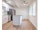 Stylish kitchen features stainless steel appliances, white cabinetry, island and a hardwood floor at 2412 53Rd S St, Gulfport, FL 33707