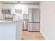 Stainless steel appliances, white cabinets, and granite countertops make for a lovely kitchen at 2412 53Rd S St, Gulfport, FL 33707