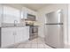 Updated kitchen featuring stainless steel appliances, white cabinetry, and granite countertops at 2412 53Rd S St, Gulfport, FL 33707