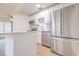 Modern kitchen features stainless steel appliances, white cabinets, an island and hardwood floors at 2412 53Rd S St, Gulfport, FL 33707