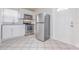 Kitchen featuring white cabinets, stainless steel appliances, and durable tile flooring at 2412 53Rd S St, Gulfport, FL 33707