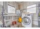 Bright laundry area featuring modern washer, shelving, and ample natural light at 2412 53Rd S St, Gulfport, FL 33707