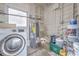 Functional laundry area with a washing machine and water heater, paint and utility supplies at 2412 53Rd S St, Gulfport, FL 33707