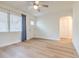 Living room with wood-look floors features bright windows and door to hallway at 2412 53Rd S St, Gulfport, FL 33707
