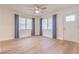 Open living room with hardwood flooring, a ceiling fan, and natural light from the large windows at 2412 53Rd S St, Gulfport, FL 33707