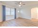 Living room features bright windows and door to hallway, ceiling fan, and wood-look floors at 2412 53Rd S St, Gulfport, FL 33707