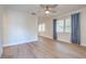 Spacious living room boasts wood floors, a ceiling fan, and natural light from the large window at 2412 53Rd S St, Gulfport, FL 33707