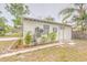 Exterior view of a detached outbuilding, complete with a separate entrance and landscaping at 2412 53Rd S St, Gulfport, FL 33707