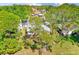 The aerial view showcases a home with well-maintained landscaping, surrounded by lush greenery and mature trees at 2507 Royal Pines Cir # 2H, Clearwater, FL 33763