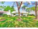 Charming home boasts a well-maintained backyard with lush green grass and mature trees, offering serene outdoor living at 2507 Royal Pines Cir # 2H, Clearwater, FL 33763