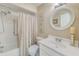 Cozy bathroom featuring a shower/tub combo, decorative mirror, vanity, and neutral finishes at 2507 Royal Pines Cir # 2H, Clearwater, FL 33763