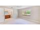 Inviting bedroom with neutral carpet, large window, ceiling fan, and ensuite bathroom at 2507 Royal Pines Cir # 2H, Clearwater, FL 33763