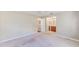 Spacious bedroom featuring neutral carpet, ceiling fan, and an open doorway to the attached bathroom at 2507 Royal Pines Cir # 2H, Clearwater, FL 33763