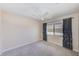 Simple bedroom with neutral walls, ceiling fan, carpeting, and a window with dark curtains at 2507 Royal Pines Cir # 2H, Clearwater, FL 33763