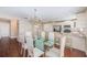 Bright dining area featuring a glass table, chandelier, and wood-look tile flooring at 2507 Royal Pines Cir # 2H, Clearwater, FL 33763