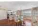 Open dining area featuring a glass table set, bright light fixture, and neutral cabinets at 2507 Royal Pines Cir # 2H, Clearwater, FL 33763