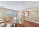 Dining area with chandelier, wood-look floors, and view to living room at 2507 Royal Pines Cir # 2H, Clearwater, FL 33763