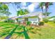 Rear exterior highlighting the lush lawn, beautiful landscaping, and private backyard of the property at 2507 Royal Pines Cir # 2H, Clearwater, FL 33763