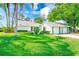 Beautiful property featuring lush green lawn and tropical trees, perfect for outdoor enjoyment at 2507 Royal Pines Cir # 2H, Clearwater, FL 33763