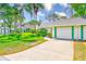 Charming villa featuring an attached garage, lush landscaping, and a well-manicured lawn at 2507 Royal Pines Cir # 2H, Clearwater, FL 33763