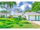 Charming home with lush lawn, mature trees, and a well-maintained exterior at 2507 Royal Pines Cir # 2H, Clearwater, FL 33763