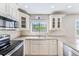 Well-lit kitchen featuring stainless steel appliances and granite countertops at 2507 Royal Pines Cir # 2H, Clearwater, FL 33763