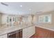 Open floor plan with kitchen island, dining area, and wood-look tile flooring at 2507 Royal Pines Cir # 2H, Clearwater, FL 33763