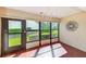 Bright sunroom featuring multiple windows offering scenic views, and stylish floors at 2507 Royal Pines Cir # 2H, Clearwater, FL 33763