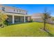 Large, well-maintained backyard features a screened patio and lush green grass, great for outdoor activities at 2612 Leafwing Ct, Palm Harbor, FL 34683