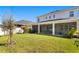 Expansive backyard with a covered screened-in patio, perfect for entertaining or relaxing outdoors at 2612 Leafwing Ct, Palm Harbor, FL 34683